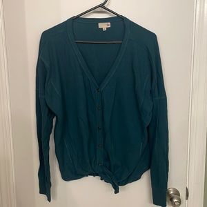 Teal blue button up sweater.